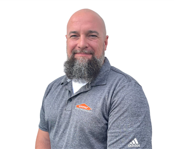 Man with beard in a gray SERVPRO shirt against white backdrop